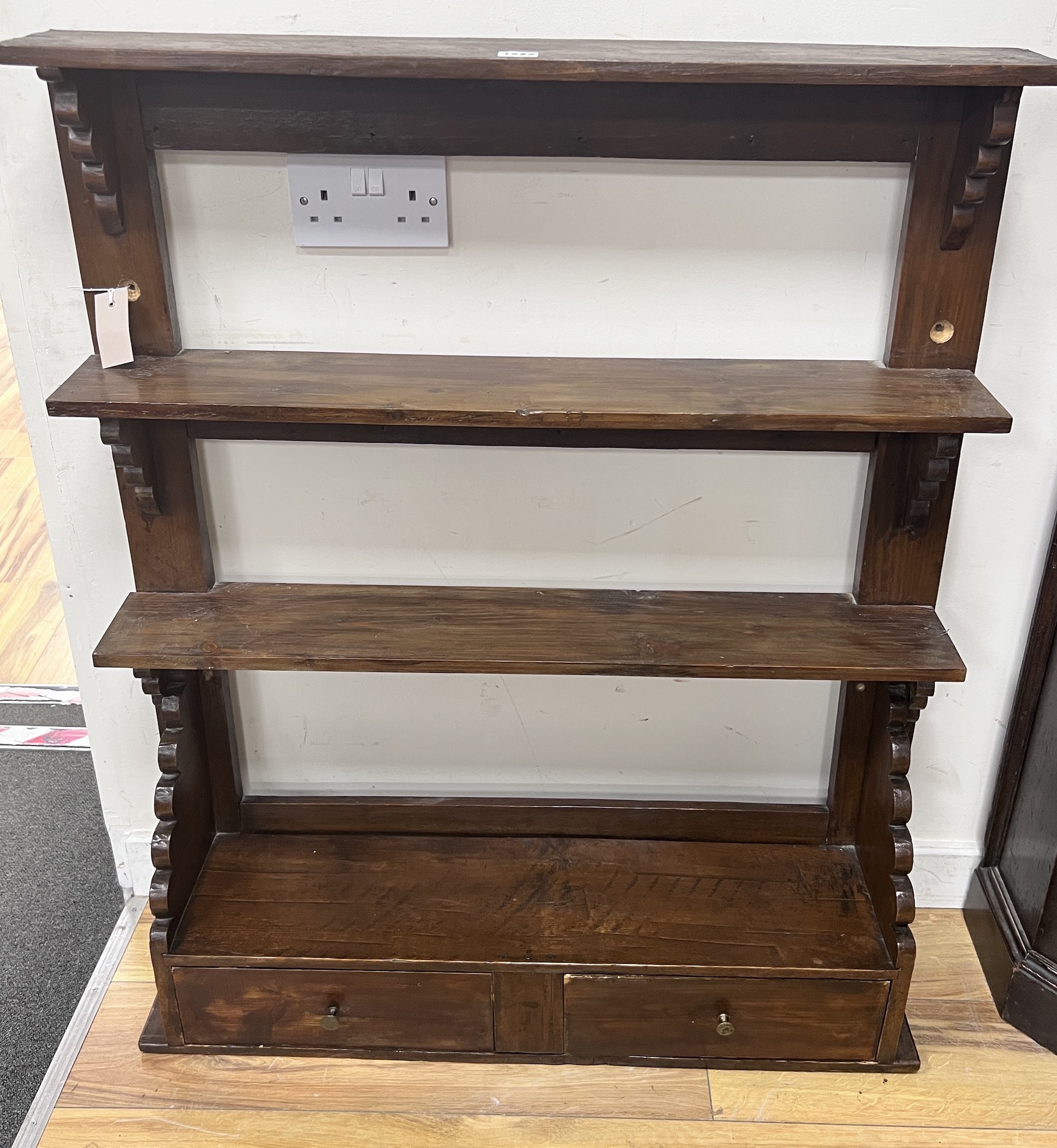 A provincial pine four tier hanging wall bracket, width 85cm, depth 21cm, height 102cm
